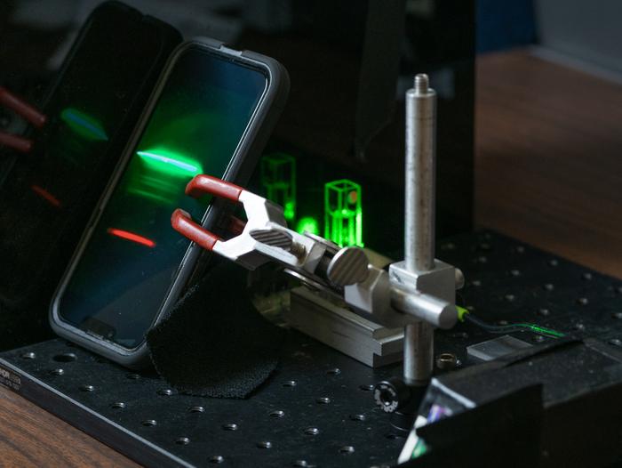 A smartphone records the Raman spectrum of an unknown material (an ethanol solution, in this case) for further analysis. 
CREDIT Texas A&M University Engineering